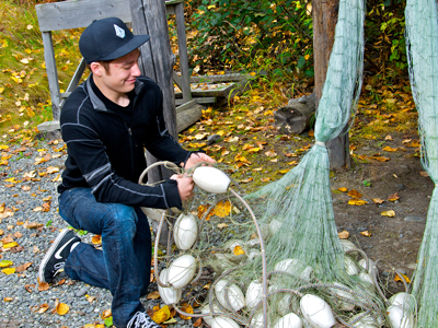 A man on knee holding fishing net