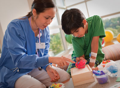 A nurse playing with a kid patient" class="mcnImageAlignRight