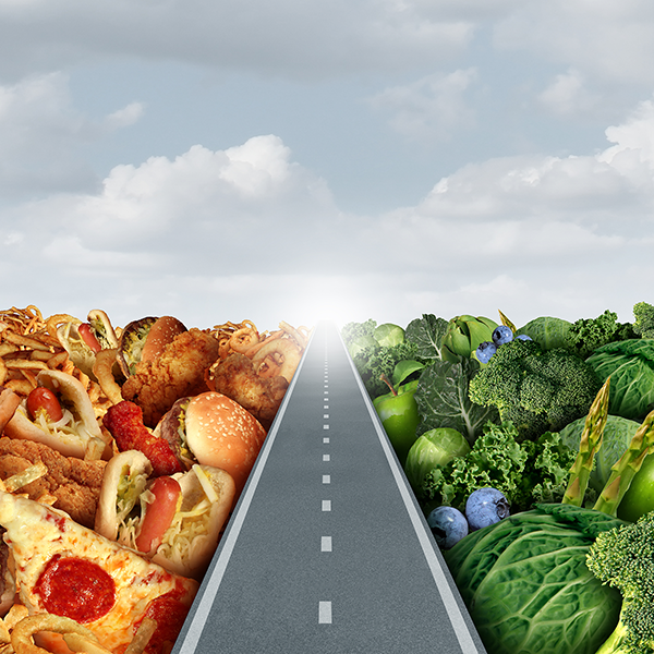 A road with junk food on the left and fruits and vegetables on the right