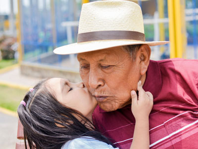 A girl kissing her grandpa