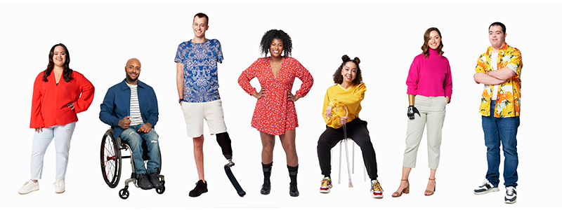 A group of seven adults with various disabilities against a white background